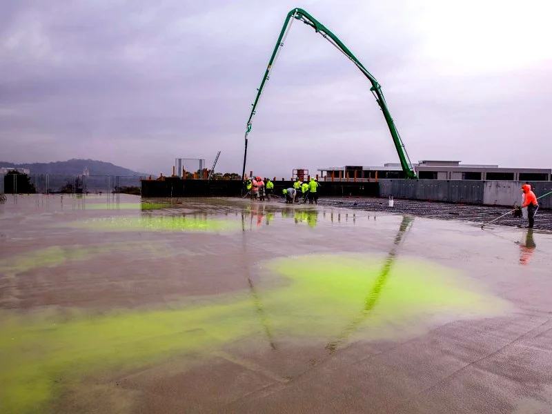 Penetron Admix green tracer visible in fresh concrete during a pour, used for quality control